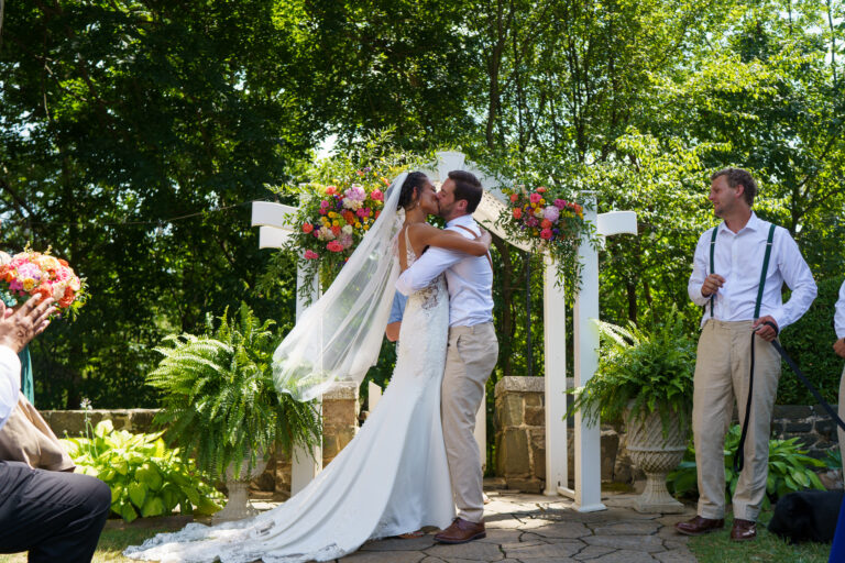 Jess and Jake exchanging vows under the arbor at Rockfield Manor