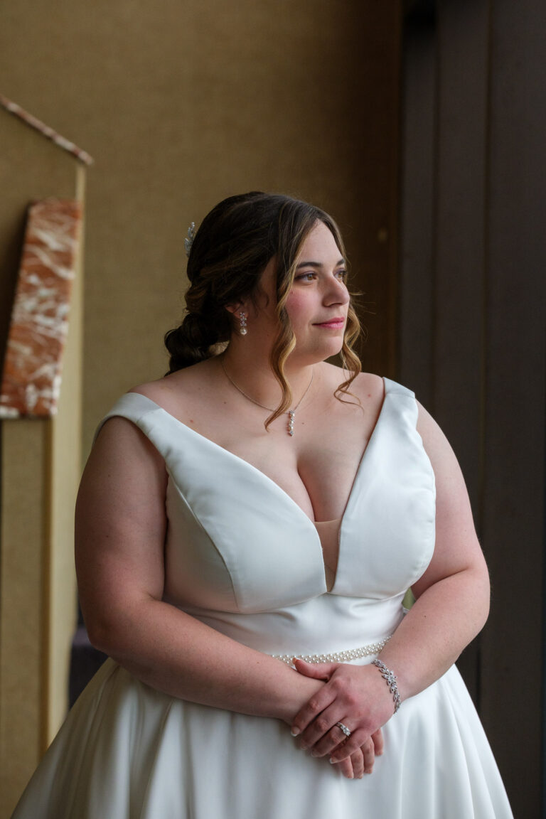 Maddie in her wedding dress by the window at Heritage Hills Golf Resort