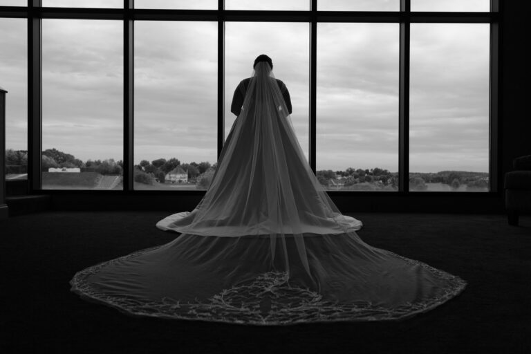 Maddie silhouetted in her long veil against the window at Heritage Hills Golf Resort