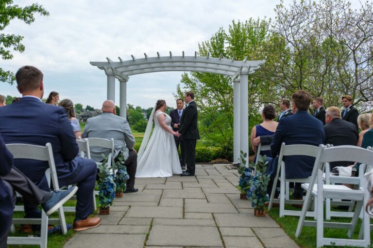Wide view of the outdoor wedding ceremony under the pergola at Heritage Hills Golf Resort