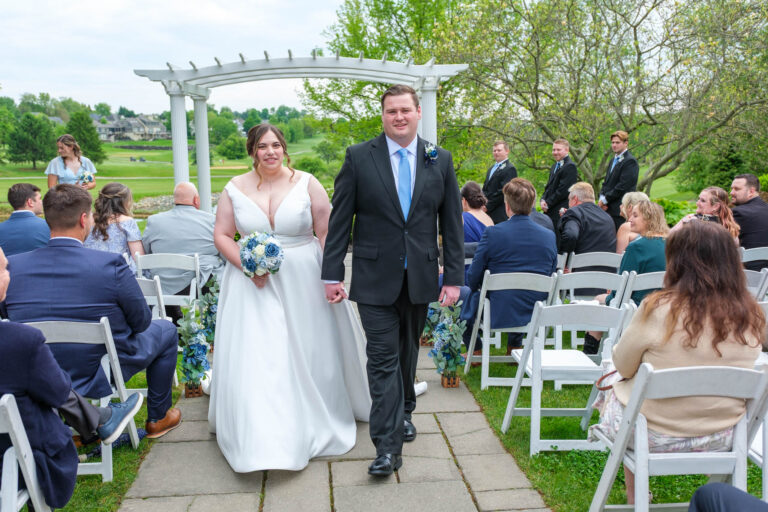 Dan and Maddie walking back up the aisle as newlyweds at Heritage Hills Golf Resort