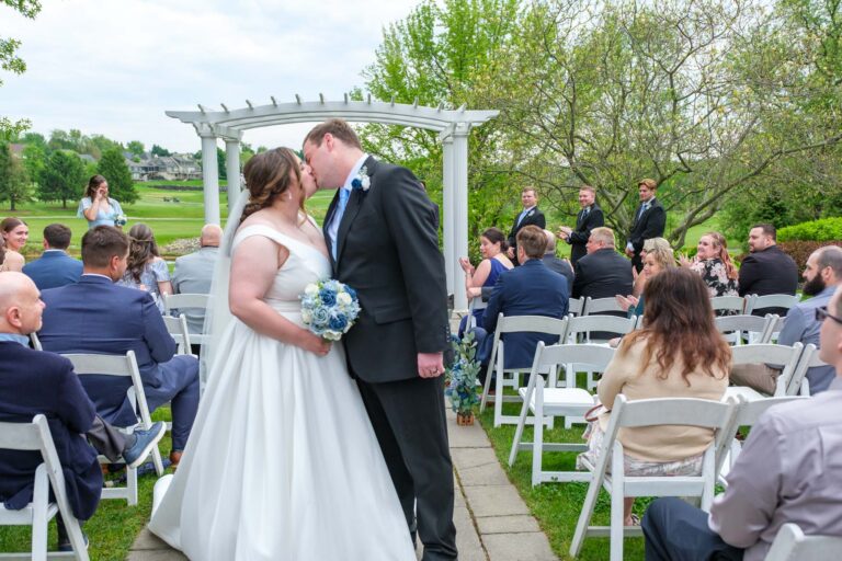 Dan and Maddie celebrating at the end of their outdoor ceremony at Heritage Hills