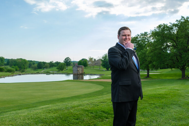 Dan on the golf course with the pond behind him at Heritage Hills Golf Resort