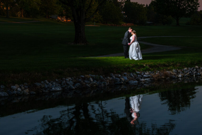 Dan and Maddie by the pond at dusk at Heritage Hills Golf Resort