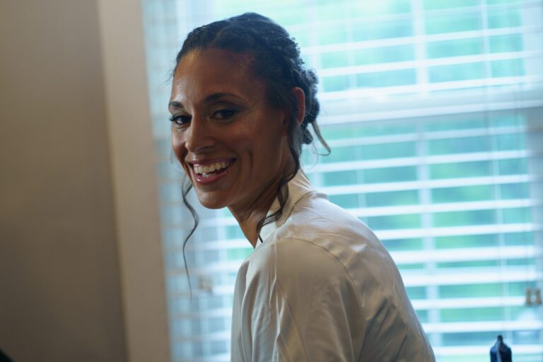 Jess smiling while getting ready for her Rockfield Manor wedding in Bel Air, MD