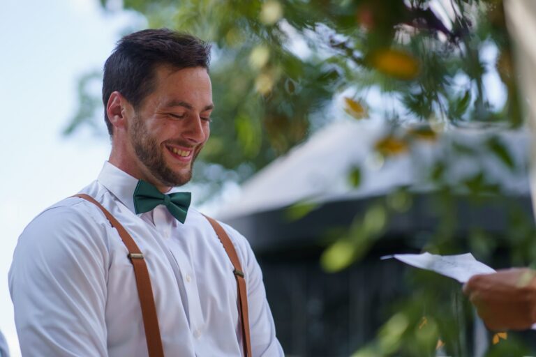 Jake smiling while reading his vows at their Rockfield Manor wedding in Bel Air, MD