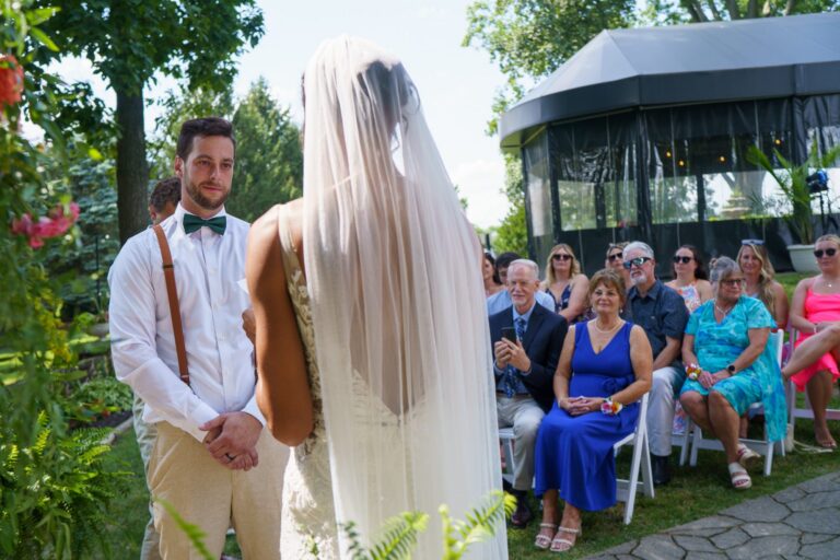 Jess and Jake at the altar with guests watching at Rockfield Manor
